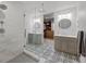 Modern bathroom showcasing a glass shower, dual vanities, and a view into the walk-in closet at 6769 E Costilla Cir, Centennial, CO 80112
