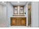 Bathroom with double sink vanity, elegant mirrors, walk-in shower, and a closet for ample storage at 6769 E Costilla Cir, Centennial, CO 80112