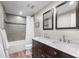 Bathroom featuring double sinks, a tub with a shower, and modern fixtures for a functional space at 6769 E Costilla Cir, Centennial, CO 80112