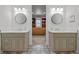 Elegant bathroom with double vanities, decorative mirrors, and a walk-in closet at 6769 E Costilla Cir, Centennial, CO 80112
