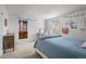 Light-filled bedroom featuring a sliding barn door to a bathroom, creating a tranquil, en-suite space at 6769 E Costilla Cir, Centennial, CO 80112