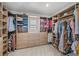A well-organized walk-in closet with custom wood shelving, drawers and a window for natural light at 6769 E Costilla Cir, Centennial, CO 80112