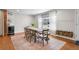 Dining room features hardwood floors, a large window, dining set, and built-in shelving at 6769 E Costilla Cir, Centennial, CO 80112