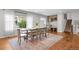 Spacious dining room features hardwood floors, a large window, dining set, and an entry area with bench at 6769 E Costilla Cir, Centennial, CO 80112