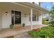 Inviting front porch with a beautiful front door and colorful flower arrangements at 6769 E Costilla Cir, Centennial, CO 80112