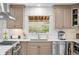 Well-lit kitchen featuring white countertops, stainless steel appliances, and white subway tile at 6769 E Costilla Cir, Centennial, CO 80112