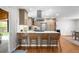 Open kitchen features stainless steel appliances, light countertops, ample cabinet space, and bar stool seating at 6769 E Costilla Cir, Centennial, CO 80112