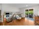 Upstairs living area with hardwood floors, sitting area, and sliding doors leading to the patio at 6769 E Costilla Cir, Centennial, CO 80112