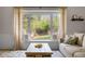 Cozy living room with a large window seat overlooking the landscaped backyard and a neutral color palette at 6769 E Costilla Cir, Centennial, CO 80112