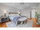 Bright main bedroom with a comfortable bed, side tables, and hardwood floors at 6769 E Costilla Cir, Centennial, CO 80112