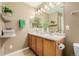 Double vanity bathroom with wood cabinets and a large mirror at 6344 E 137Th Ave, Thornton, CO 80602