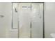 Walk-in shower with bench seat and frosted glass door at 6344 E 137Th Ave, Thornton, CO 80602