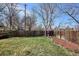 Spacious backyard featuring a well-maintained lawn and tall wooden privacy fence at 1281 S Allison St, Lakewood, CO 80232