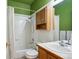 Well-lit bathroom features a shower-tub combo and a wood vanity with coordinated medicine cabinet at 1281 S Allison St, Lakewood, CO 80232
