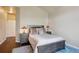 Cozy bedroom with hardwood floors, soft lighting, and stylish neutral-toned decor at 1281 S Allison St, Lakewood, CO 80232