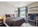 Bedroom with hardwood floors and large window providing natural light, plus a desk setup at 1281 S Allison St, Lakewood, CO 80232
