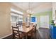 The dining room features hardwood floors, natural light, and a blue-painted front door at 1281 S Allison St, Lakewood, CO 80232