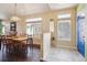 The dining room features hardwood floors, natural light, and a blue-painted front door at 1281 S Allison St, Lakewood, CO 80232