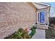 This home features a brick exterior wall, a covered front entry, and landscaped accents at 1281 S Allison St, Lakewood, CO 80232