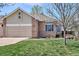 Charming single-Gathering home features a well-maintained front yard and an attached two-car garage at 1281 S Allison St, Lakewood, CO 80232