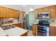 Bright kitchen featuring white countertops, stainless steel appliances, and light wood cabinetry at 1281 S Allison St, Lakewood, CO 80232