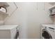 Functional laundry room with washer and dryer hookups and built in shelving for easy organization at 1281 S Allison St, Lakewood, CO 80232