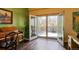 Open living room featuring wood floors and bright light from the double doors leading to the outdoor deck at 1281 S Allison St, Lakewood, CO 80232