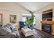 Cozy living room with a fireplace, large windows, and comfortable seating for relaxation at 1281 S Allison St, Lakewood, CO 80232