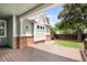Inviting covered back porch featuring wood floors and view of the backyard at 1544 S Elizabeth St, Denver, CO 80210