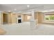 A spacious basement with a fireplace, windows, and neutral carpet at 1544 S Elizabeth St, Denver, CO 80210