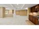 A large basement with a partial kitchen, neutral carpet, and recessed lighting at 1544 S Elizabeth St, Denver, CO 80210