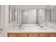A bathroom with a double vanity with mirror and tile countertop at 1544 S Elizabeth St, Denver, CO 80210