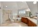 Luxurious bathroom featuring a glass-enclosed shower, soaking tub, and dual sinks at 1544 S Elizabeth St, Denver, CO 80210