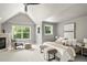 Bright bedroom with vaulted ceilings, neutral colors, and a cozy seating area at 1544 S Elizabeth St, Denver, CO 80210