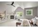 Cozy bedroom boasts vaulted ceilings, a fireplace, and a built-in bookshelf at 1544 S Elizabeth St, Denver, CO 80210