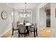 Cozy dining room showcases a modern chandelier and neutral decor, perfect for gatherings at 1544 S Elizabeth St, Denver, CO 80210
