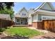 Charming two-story home showcasing a lush green lawn and inviting front porch at 1544 S Elizabeth St, Denver, CO 80210
