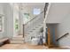 Bright foyer features a staircase with wooden handrail and hardwood floors at 1544 S Elizabeth St, Denver, CO 80210