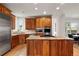 Gourmet kitchen features granite countertops and island with stainless steel appliances and wooden cabinetry at 1544 S Elizabeth St, Denver, CO 80210