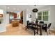 Open-concept kitchen and dining area with stainless steel appliances, wood cabinets, and hardwood floors at 1544 S Elizabeth St, Denver, CO 80210