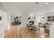 Bright and airy living room with hardwood floors, a fireplace, and an open layout to the dining area at 1544 S Elizabeth St, Denver, CO 80210