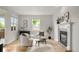 Inviting living room with a cozy fireplace, neutral decor, and hardwood flooring at 1544 S Elizabeth St, Denver, CO 80210