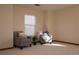 Bedroom sitting area featuring two armchairs, natural light, and carpeted floors at 4315 Bella Vista Dr, Longmont, CO 80503