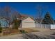 Exterior elevation of a two-story home featuring an attached garage and landscaping at 4315 Bella Vista Dr, Longmont, CO 80503