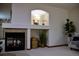 A decorative fireplace enhances the living room, complemented by arched shelving and natural decor at 4315 Bella Vista Dr, Longmont, CO 80503
