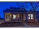 Nighttime view of a well-lit home with a charming porch, creating an inviting and secure atmosphere at 4315 Bella Vista Dr, Longmont, CO 80503