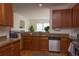Well-equipped kitchen with wood cabinets, granite countertops, and stainless-steel appliances open to the living room at 4315 Bella Vista Dr, Longmont, CO 80503