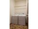 Practical laundry room equipped with side-by-side washer and dryer units with a wood door at 4315 Bella Vista Dr, Longmont, CO 80503