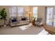 Bright living room featuring a comfortable sofa with throw pillows and a floor to ceiling window view at 4315 Bella Vista Dr, Longmont, CO 80503