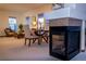 Sunlit living room with neutral carpet, fireplace, and comfortable seating arrangement, creating a cozy atmosphere at 4315 Bella Vista Dr, Longmont, CO 80503